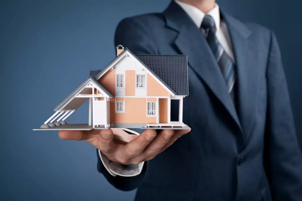 Man holding a model house